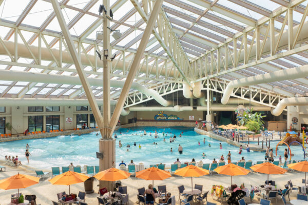 Wild Waterdome interior overview shot of The Great Wave wavepool, seating, Mini Mammoths Cove, and Dueling Mammoths.
