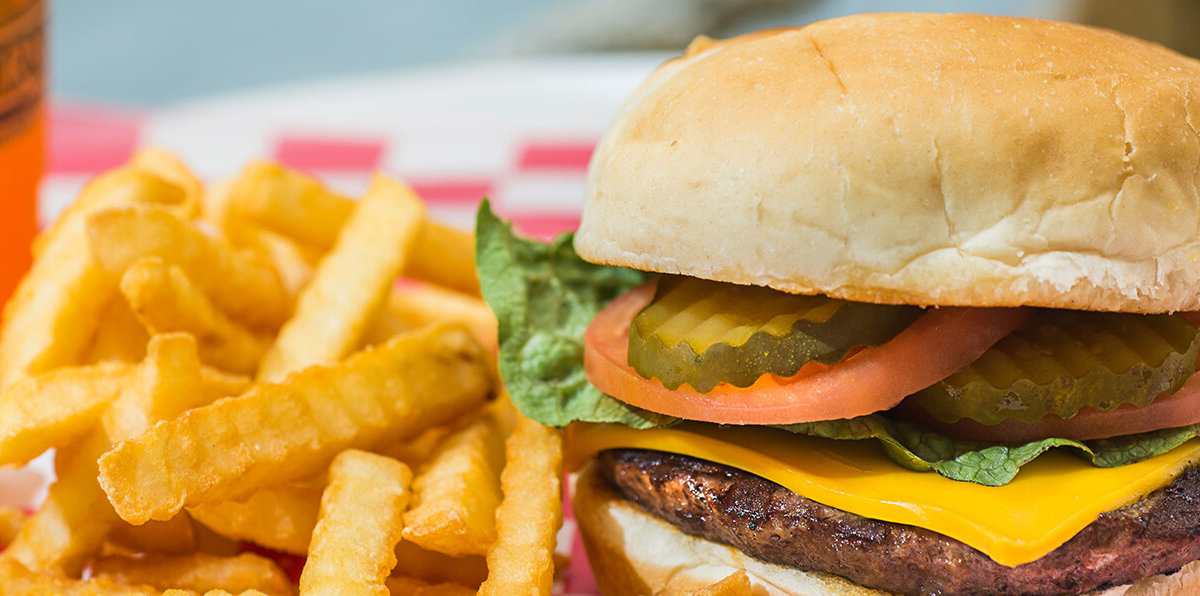 cheeseburger with french fries basket with a drink