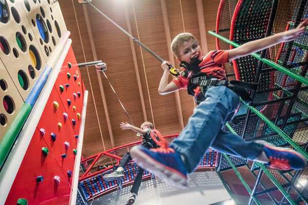 boy on clip and climb challenge wall