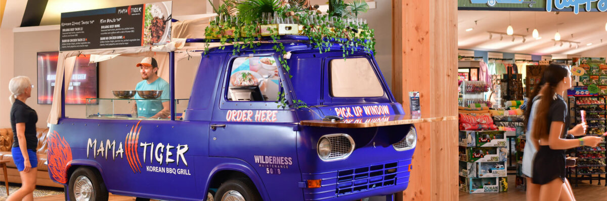 Mama Tiger decorative banner showing food truck at Camp Social located next to Happy Camper at Wilderness Resort.