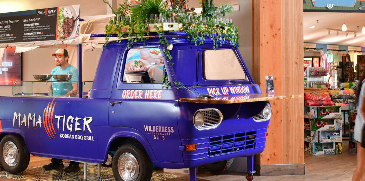 Mama Tiger decorative banner showing food truck at Camp Social located next to Happy Camper at Wilderness Resort.