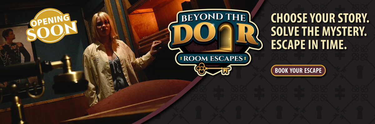 Promotional banner for Beyond the Door Room Escapes featuring a woman inside a dimly lit mystery room with text reading “Choose Your Story. Solve the Mystery. Escape in Time.” and “Opening Soon.”